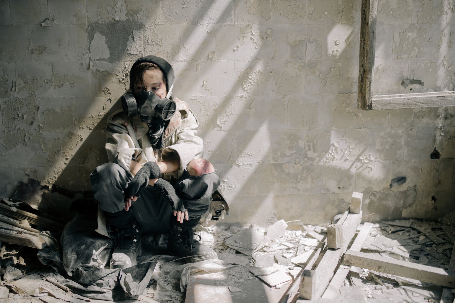 pexels-photo-4874458 - The Paris Post woman in white jacket sitting on concrete stairs | Causes of air pollution | A women wearing mask at home.