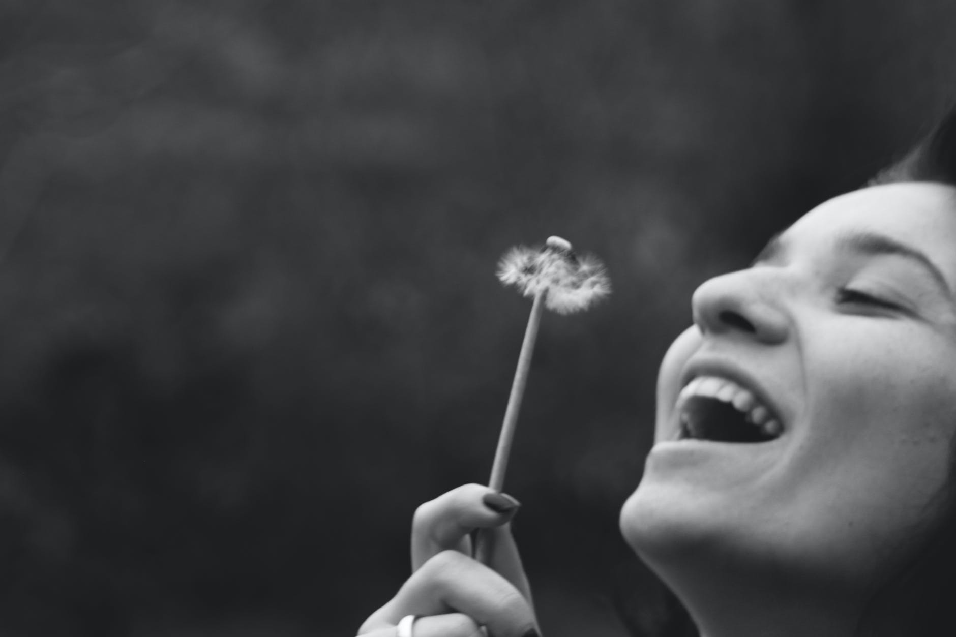 pexels-photo-403448 - The Paris Post smiling woman holding dandelion flower