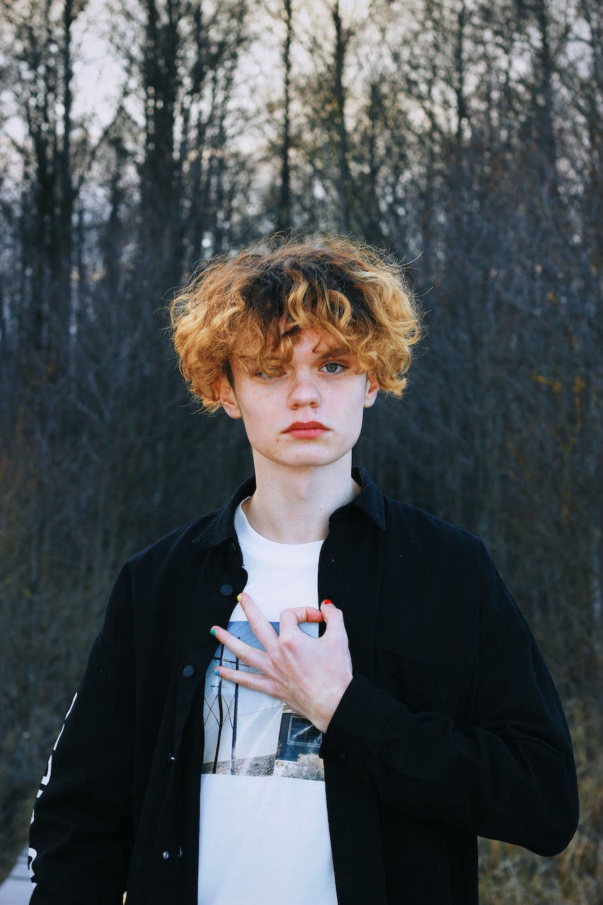 portrait of a boy with curly hair wearing a black shirt