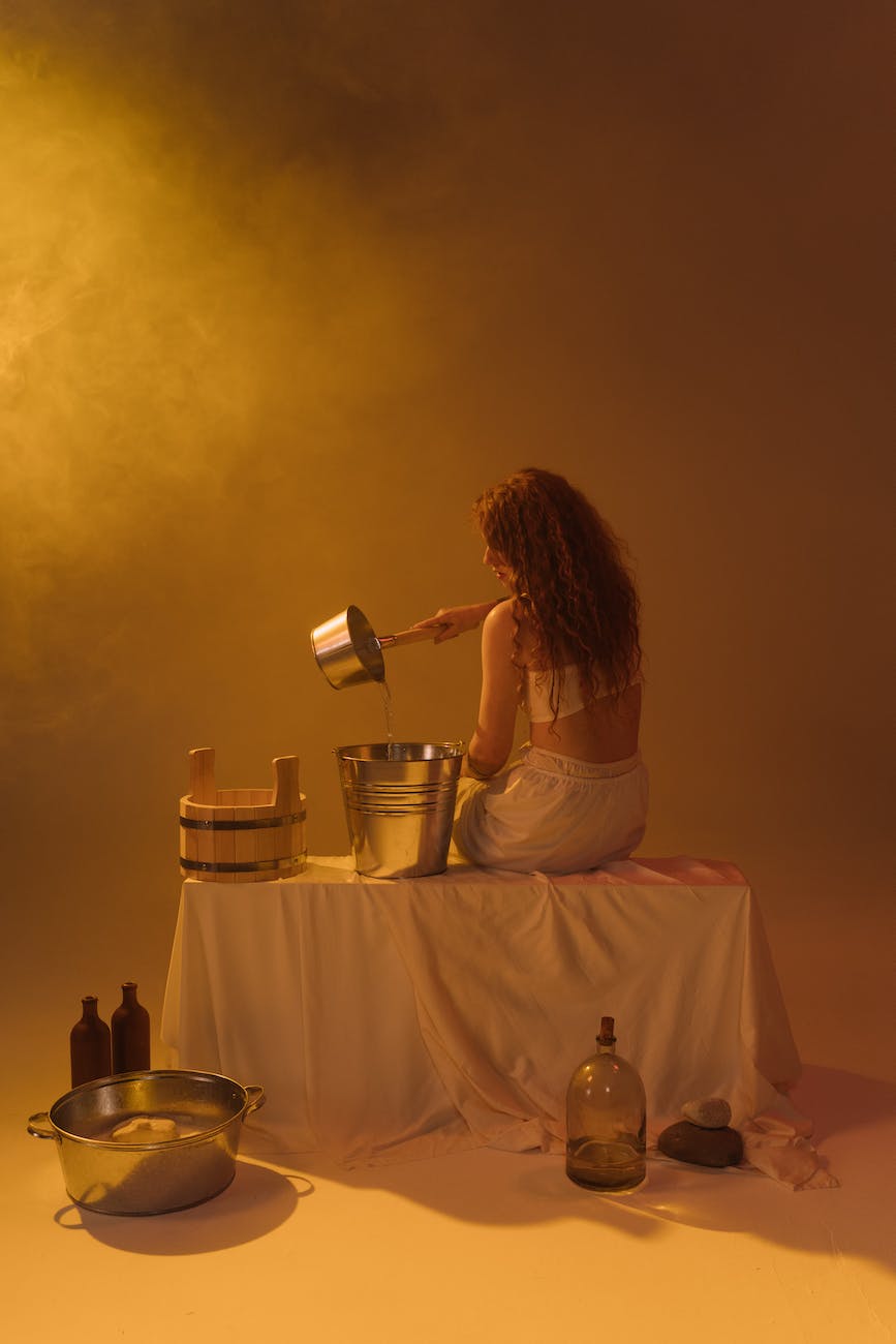 pexels-photo-8284381 - The Paris Post woman pouring water on a bucket