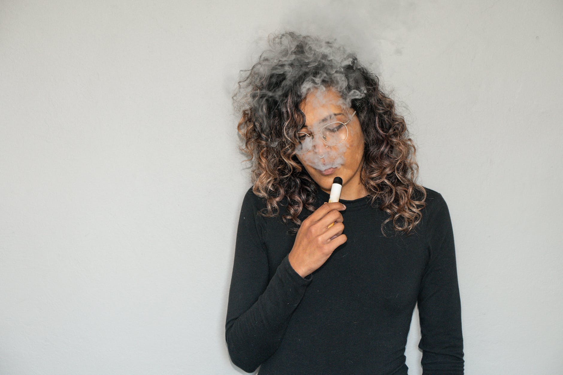 a woman using vape | E-Cigarette advertising and using is danger and cause cancer | India Banned E-Cigarette