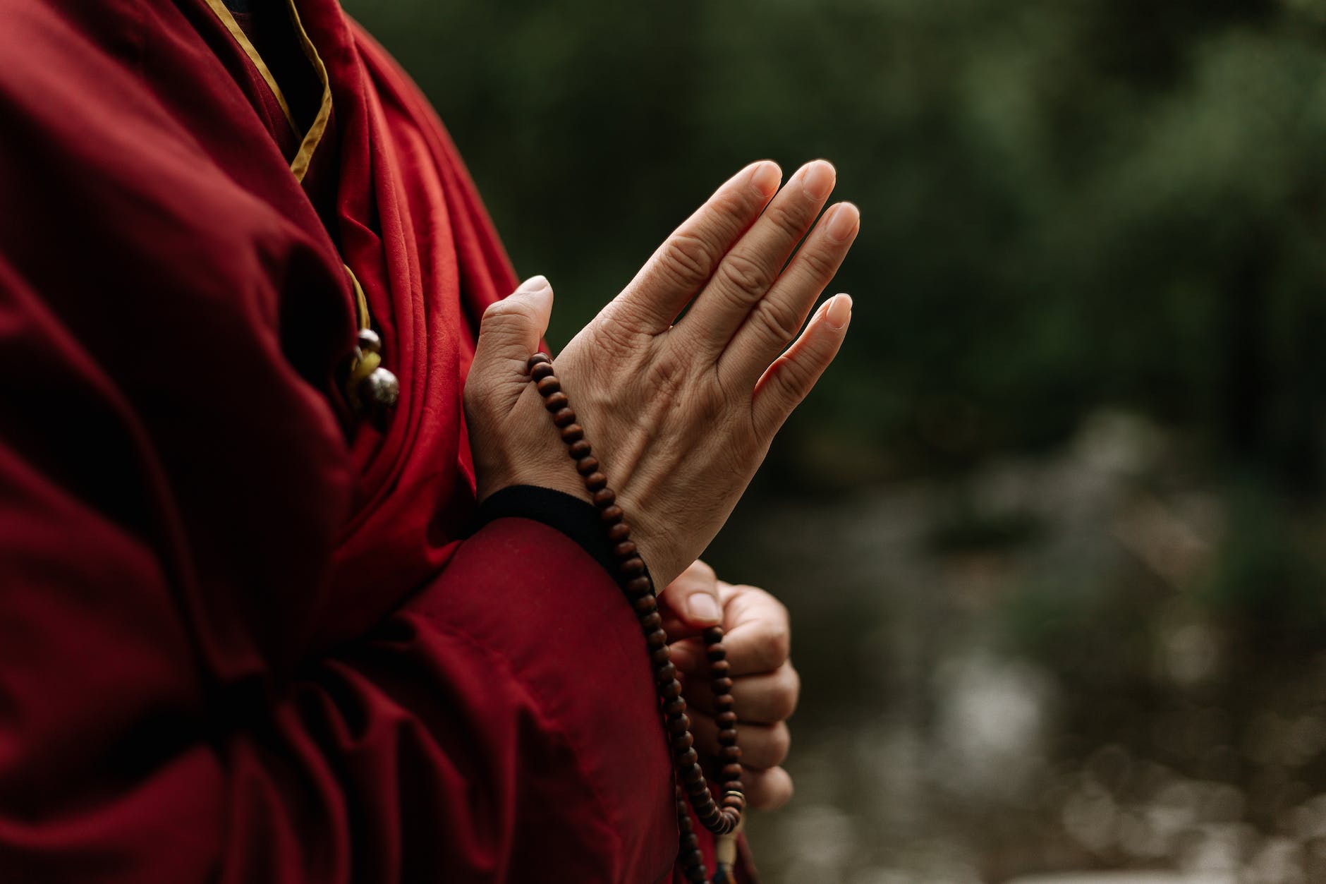 pexels-photo-5385913 - The Paris Post Culture and Faith | The Book at the Root of Your Culture and Faith | hands holding a brown prayer beads