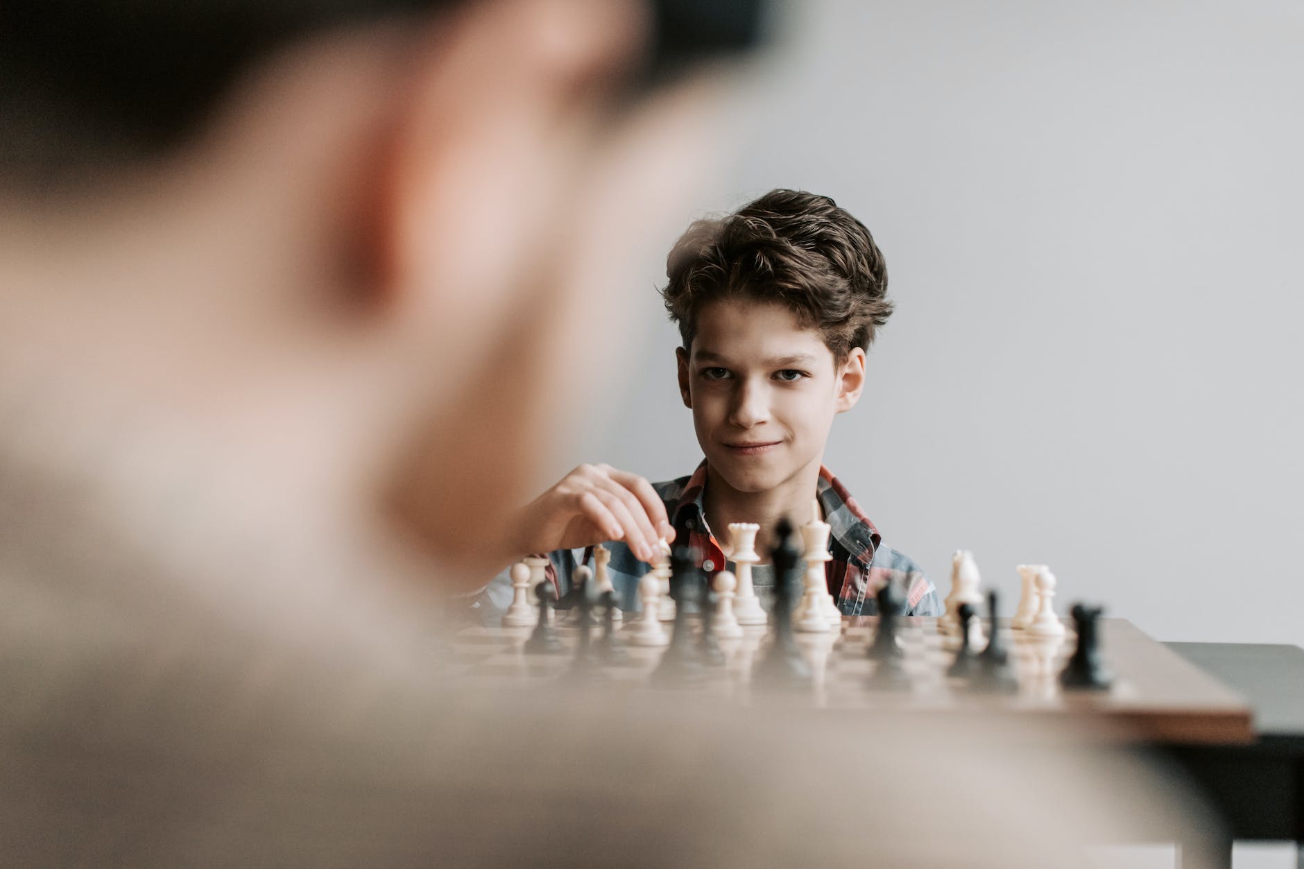 pexels-photo-6115019 - The Paris Post a boy playing chess