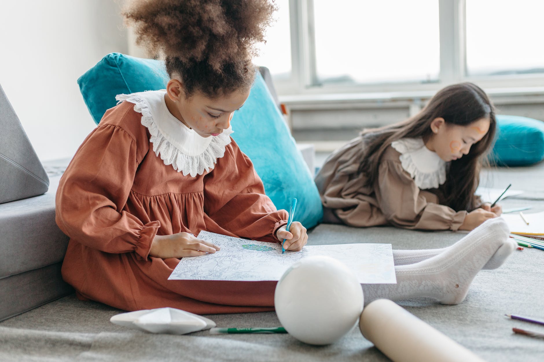 pexels-photo-6966376 - The Paris Post 9 Puzzle games for kids: girl in red dress sitting on red textile
