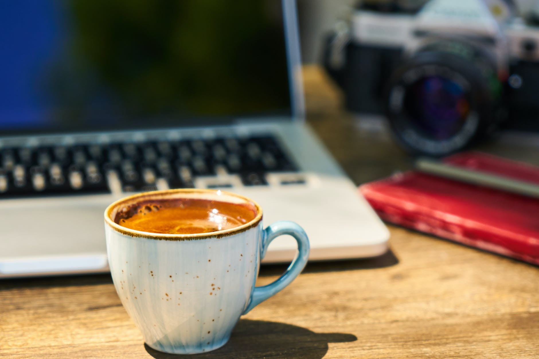 pexels-photo-2347380 - The Paris Post a cup of coffee and a camera on a wooden table in the workplace | Here are some popular press release sites submission