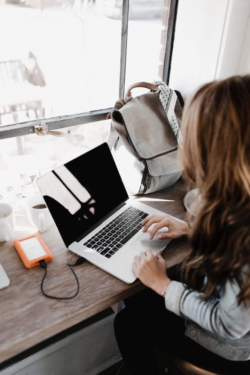 pexels-photo-3178818 - The Paris Post close up photography of woman sitting beside table while using macbook \ Creative writing prompts submission to i'mBiking