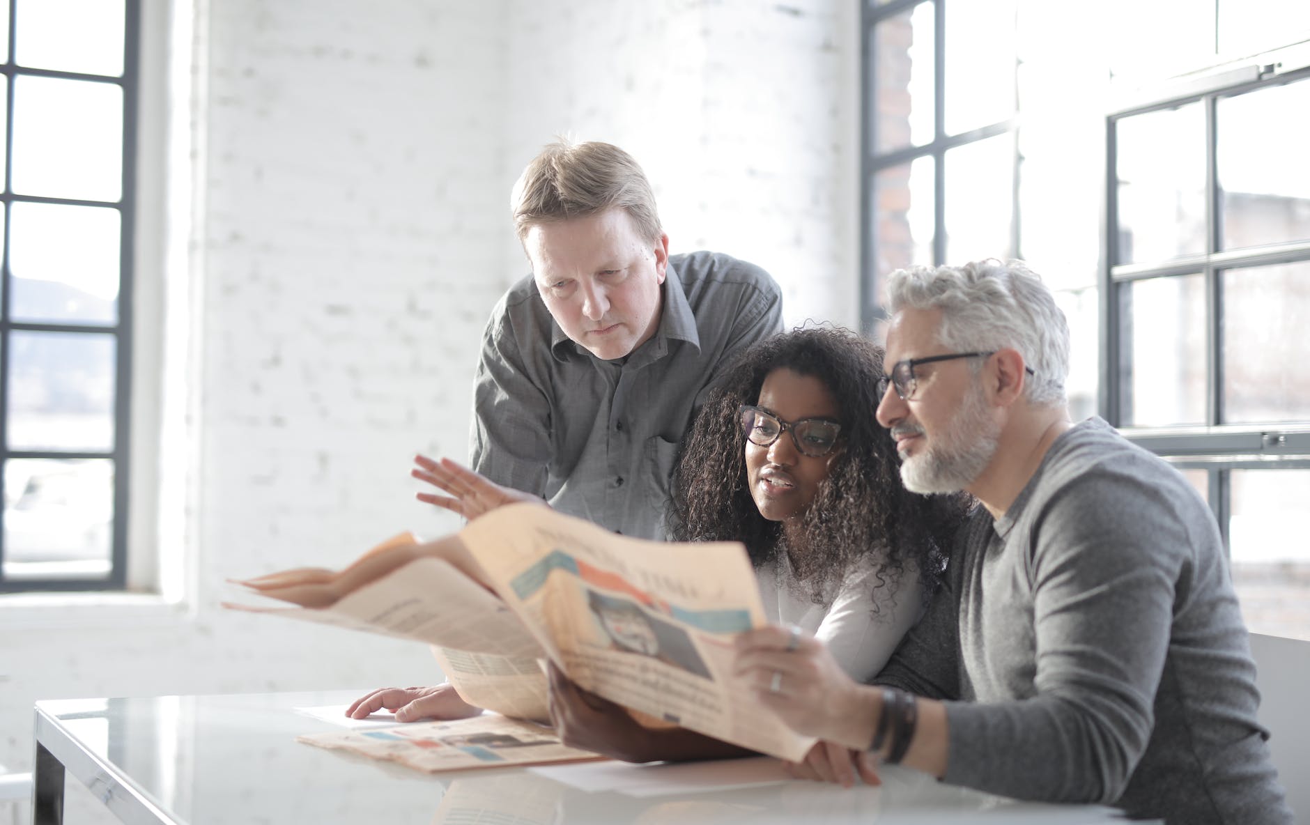 pexels-photo-3866322 - The Paris Post concentrated diverse colleagues of different ages reading newspaper together in modern workspace | Rewrite your guest post and submit to editor for publication