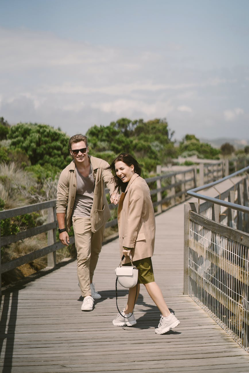 pexels-photo-4172911 - The Paris Post laughing couple walking on wooden boardwalk | Walking 30 minutes a day: Boost your strength, power, and endurance