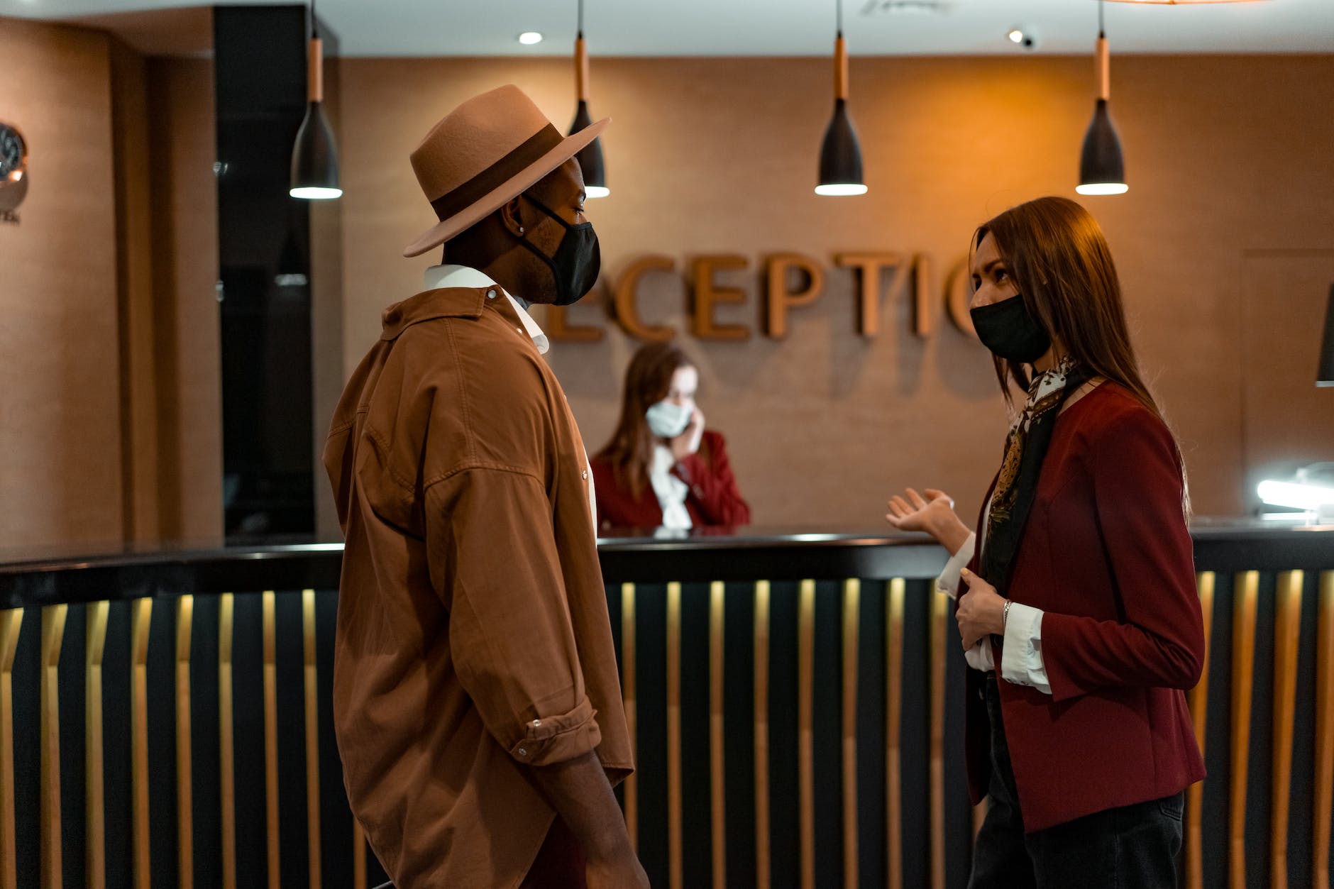 pexels-photo-7820358 - The Paris Post a man and a woman talking at the reception area | 8 Guest posting services benefits