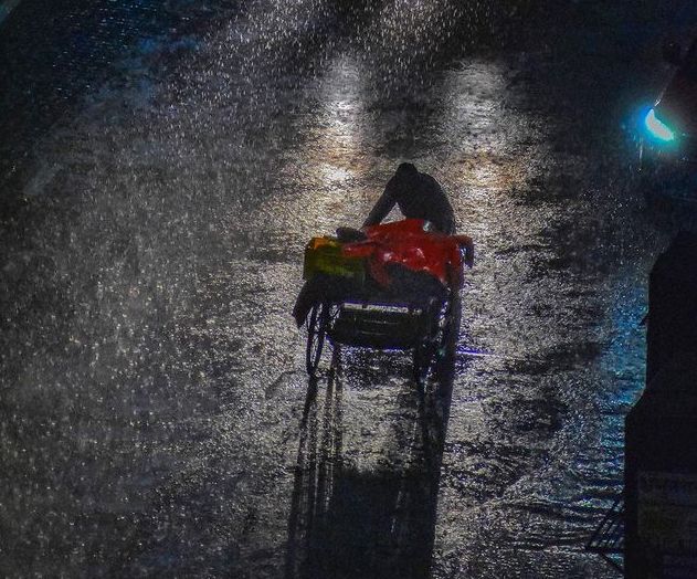 rainwater_benefits - The Paris Post a person walking in the rainwater