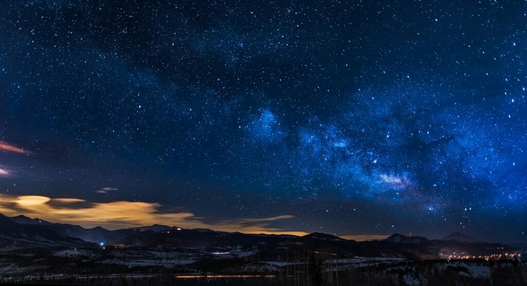 black mountains under the stars at nighttime: A soulful reflection on how every being follows a unique journey in life. Embrace differences and trust the timing of your own path.