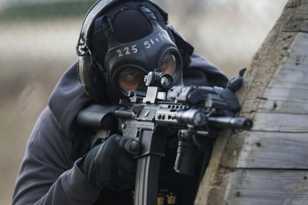 person holding airsoft gun in shallow focus lens: A powerful call for zero tolerance against terrorism—urging global unity, strategic action, and diplomacy to combat extremism and ensure peaceful coexistence.
