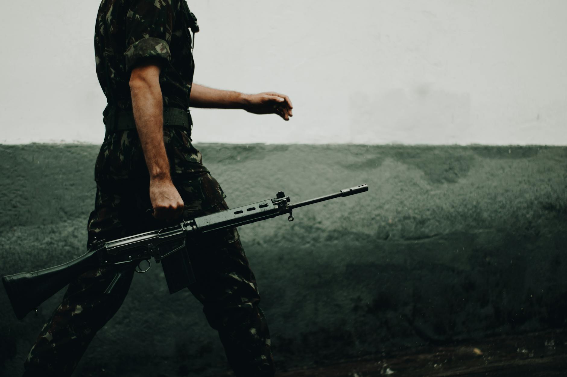 soldier holding gun: A stirring poetic reflection on the horrors of war, nuclear threat, pandemics, and modern militarization—World War Web Discourse – Never Again urges humanity to choose peace, unity, and welfare over destruction.