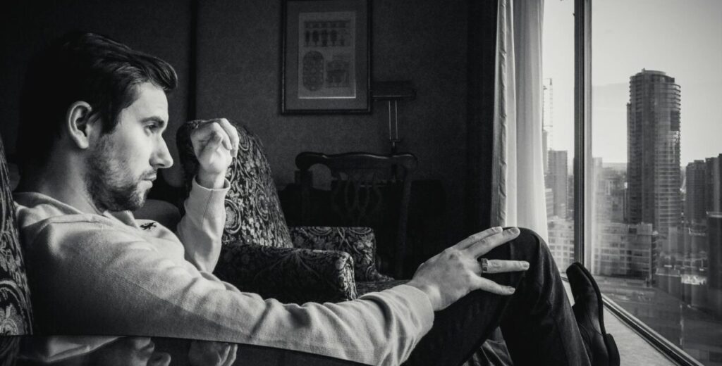grayscale photo of man looking at window: While women’s protection laws are essential, their misuse can destroy innocent lives. This opinion explores the urgent need for fairness, balance, and gender-neutral justice.