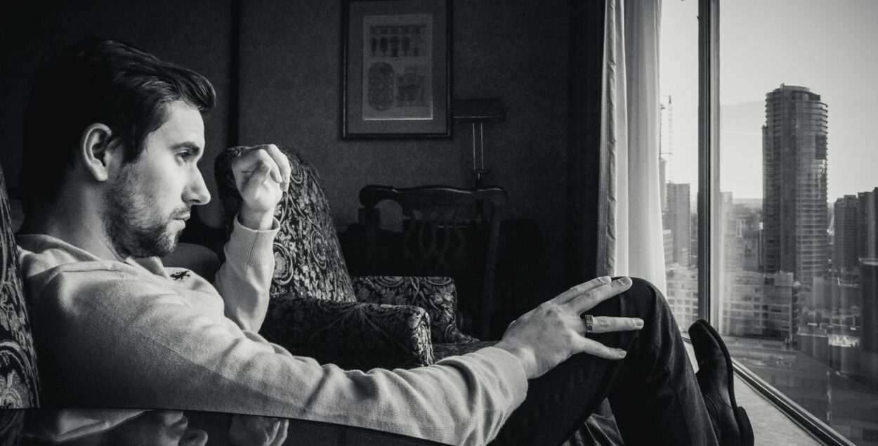 grayscale photo of man looking at window: While women’s protection laws are essential, their misuse can destroy innocent lives. This opinion explores the urgent need for fairness, balance, and gender-neutral justice.